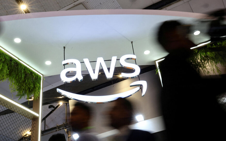 FILE PHOTO: People walk past the logo of Amazon Web Services (AWS) at its exhibitor stall at the India Mobile Congress 2025 at Yashobhoomi, a convention and expo center in New Delhi FILE PHOTO: People walk past the logo of Amazon Web Services (AWS) at its exhibitor stall at the India Mobile Congress 2025 at Yashobhoomi, a convention and expo center in New Delhi, India, October 8, 2025. REUTERS/Anushree Fadnavis/File Photo